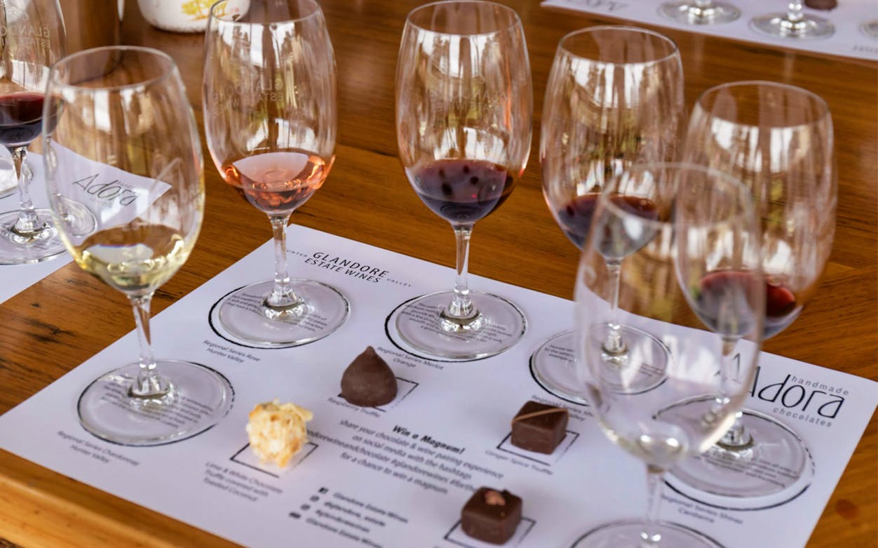 Wine tasting setup with glasses and chocolates at Hunter Valley tour.