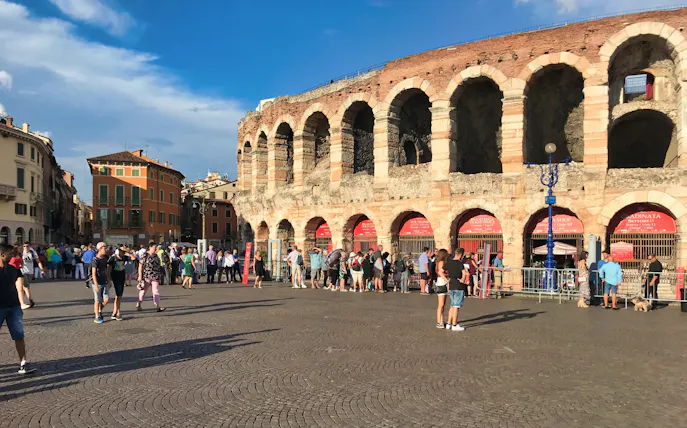 Visitors outside Arena di Verona, Italy, preparing for an opera event and city tour.