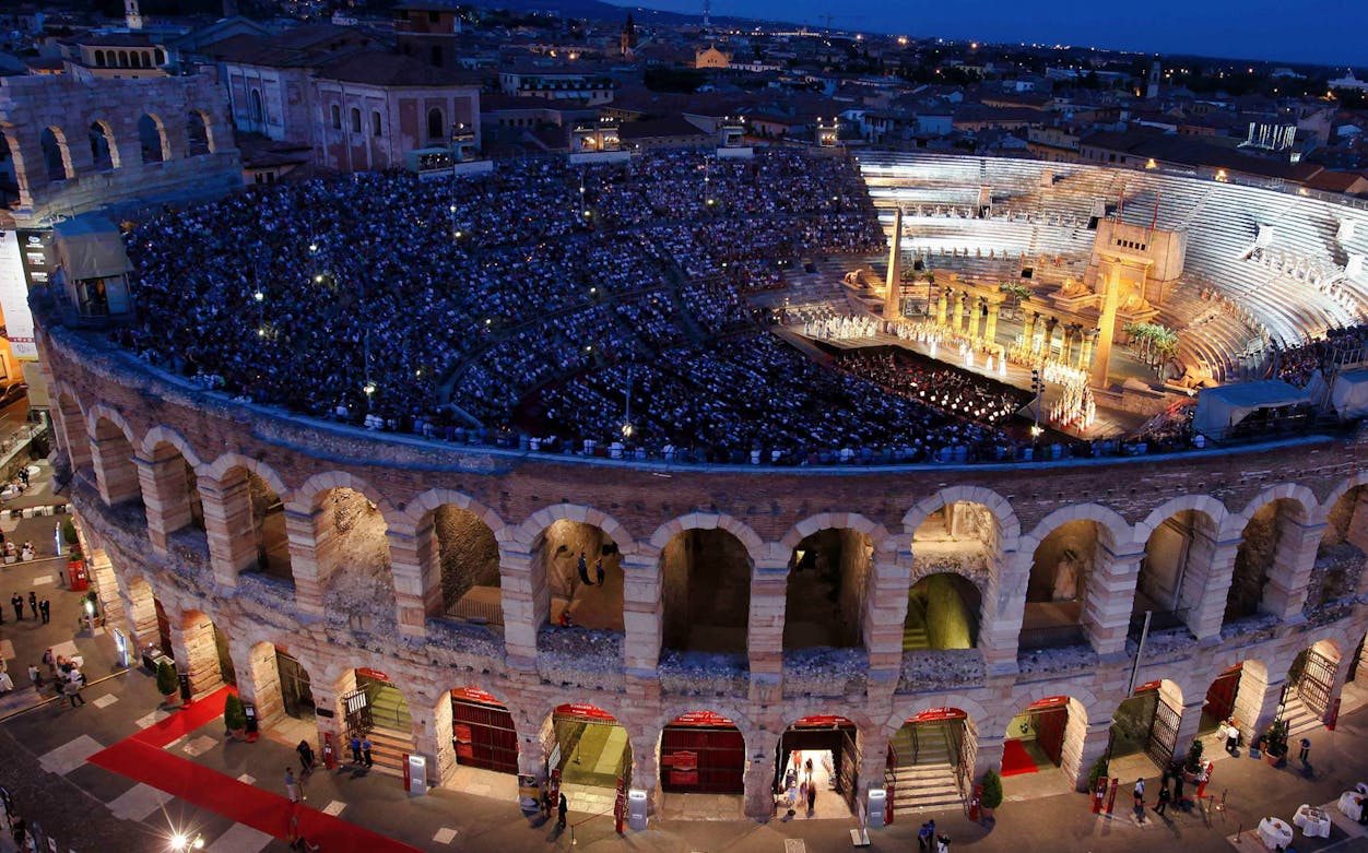 Verona Arena evening opera performance with audience, view from above.