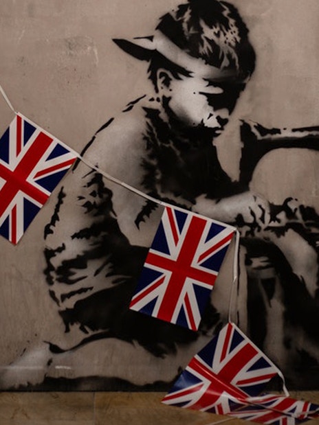 Banksy artwork of a child sewing Union Jack flags, Banksy Museum Barcelona.