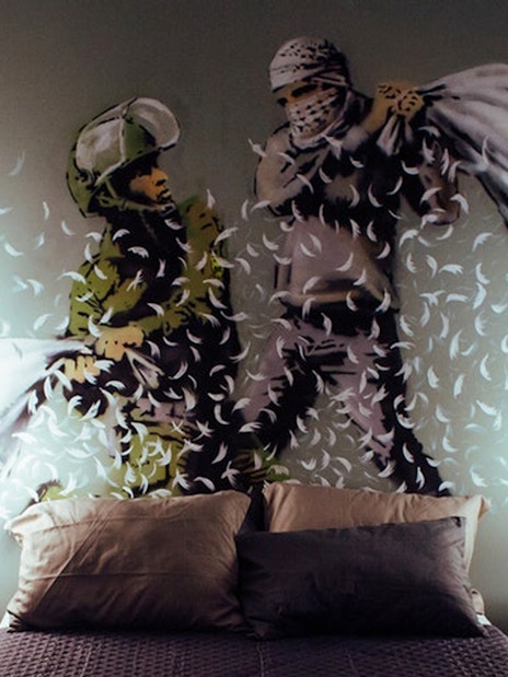 Street art mural of a pillow fight by Banksy at Moco Museum, Amsterdam.