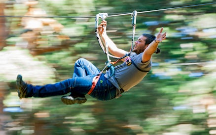 Person ziplining through forest at Aventura Amazonia.