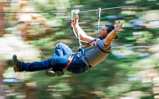 Person ziplining through forest at Aventura Amazonia.