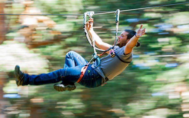 Person ziplining through forest at Aventura Amazonia.