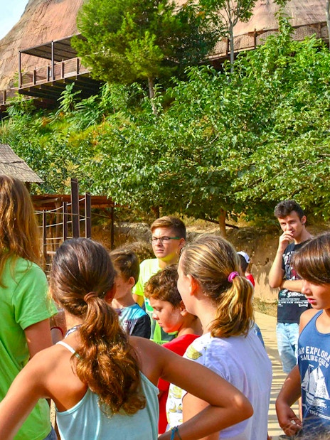 Visitors observing a camel at Terra Natura Benidorm.