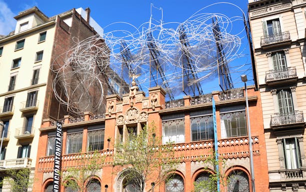 Antoni Tàpies Foundation building with unique wire sculpture on the roof in Barcelona.
