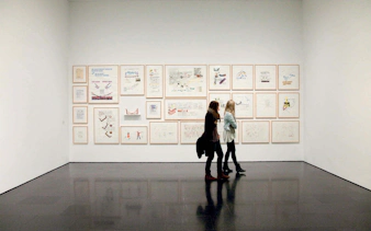 Visitors viewing framed artworks at the Museum of Contemporary Art of Barcelona (MACBA).