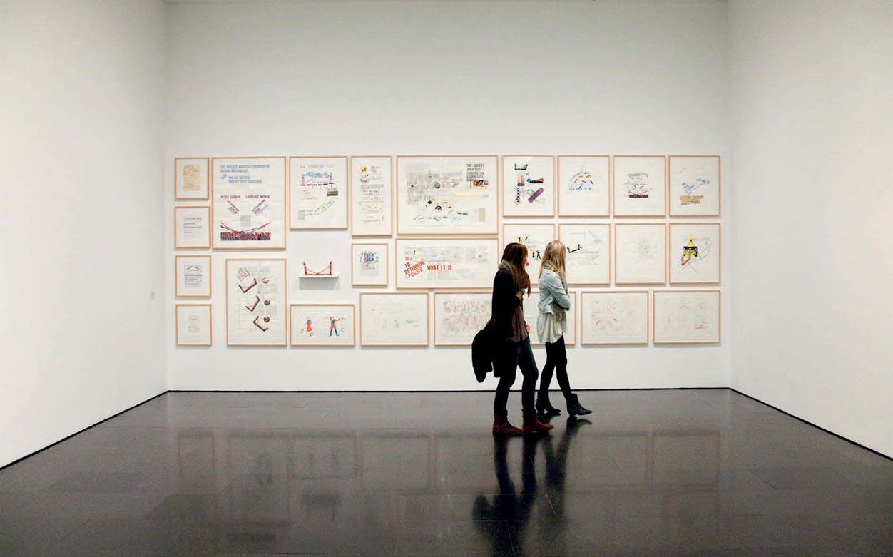 Visitors viewing framed artworks at the Museum of Contemporary Art of Barcelona (MACBA).
