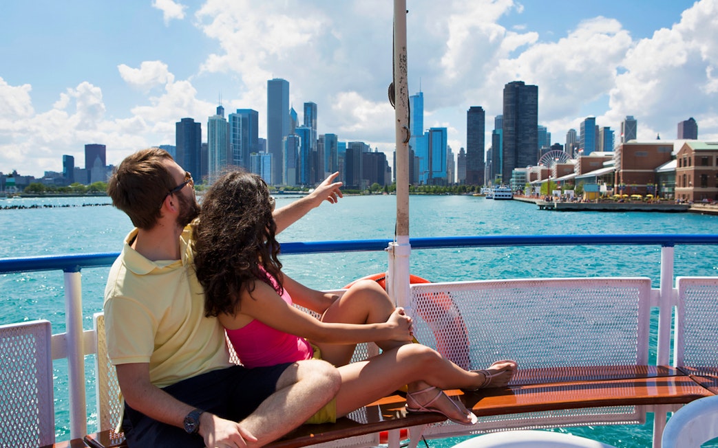 Couple enjoying Chicago skyline from a boat on Lake Michigan during a tour.