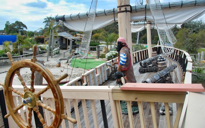 Pirate ship exhibit at Maru Koala and Animal Park, featuring cannons and a ship's wheel.