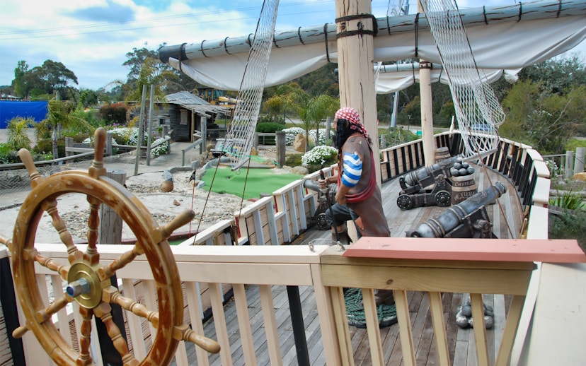 Pirate ship exhibit at Maru Koala and Animal Park, featuring cannons and a ship's wheel.