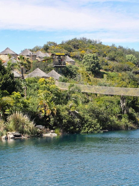 Suspension bridge over a lush landscape at Selwo Aventura, Spain.