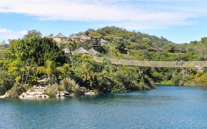 Suspension bridge over a lush landscape at Selwo Aventura, Spain.
