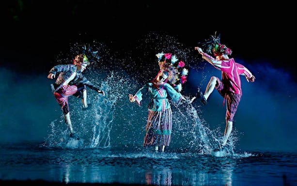 Performers in traditional costumes dance in water at El Sueño de Toledo, Puy du Fou España.