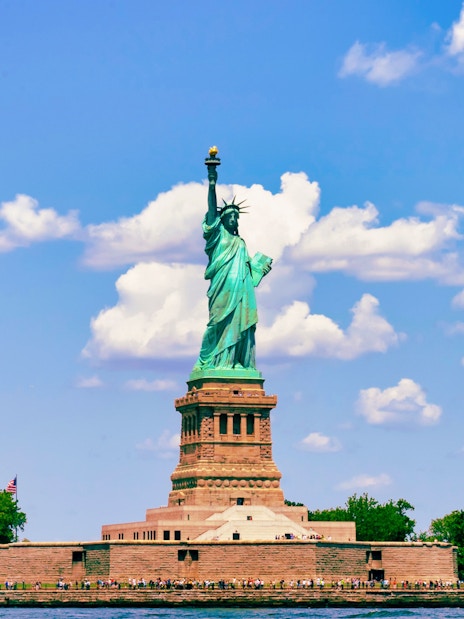 Statue of Liberty on Liberty Island, New York City, under a blue sky.