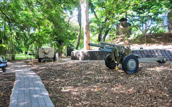 Outdoor military exhibit with artillery at Darwin Military Museum.