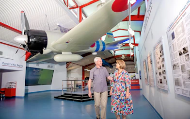 Airplane exhibit at Royal Flying Doctor Service in Darwin with visitors exploring the museum.