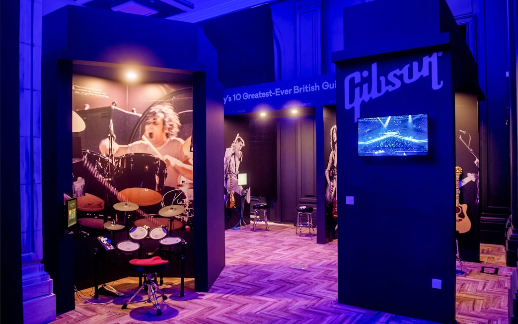 Drum exhibit at The British Music Experience, featuring iconic British musicians.