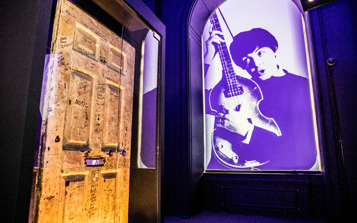 Graffitied door and musician projection at the British Music Experience.