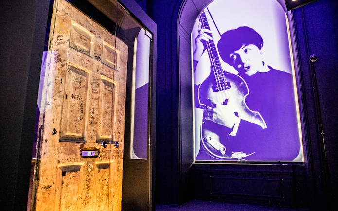 Graffitied door and musician projection at the British Music Experience.
