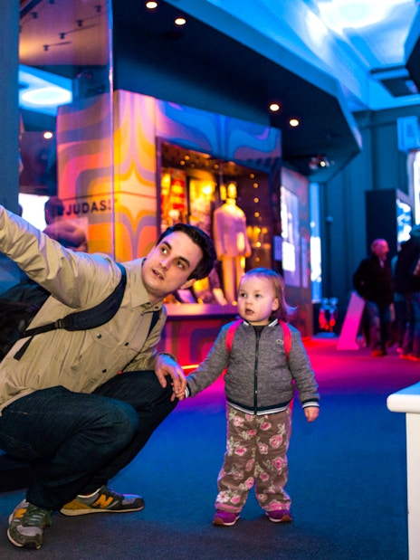 Man and child exploring exhibits at the British Music Experience in London.