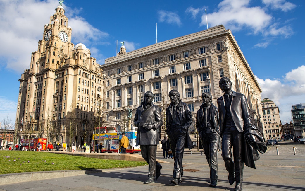 Statues of four musicians in front of the Royal Liver Building, Liverpool.