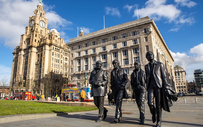 Statues of four musicians in front of the Royal Liver Building, Liverpool.