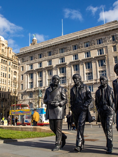 Statues of four musicians in front of the Royal Liver Building, Liverpool.