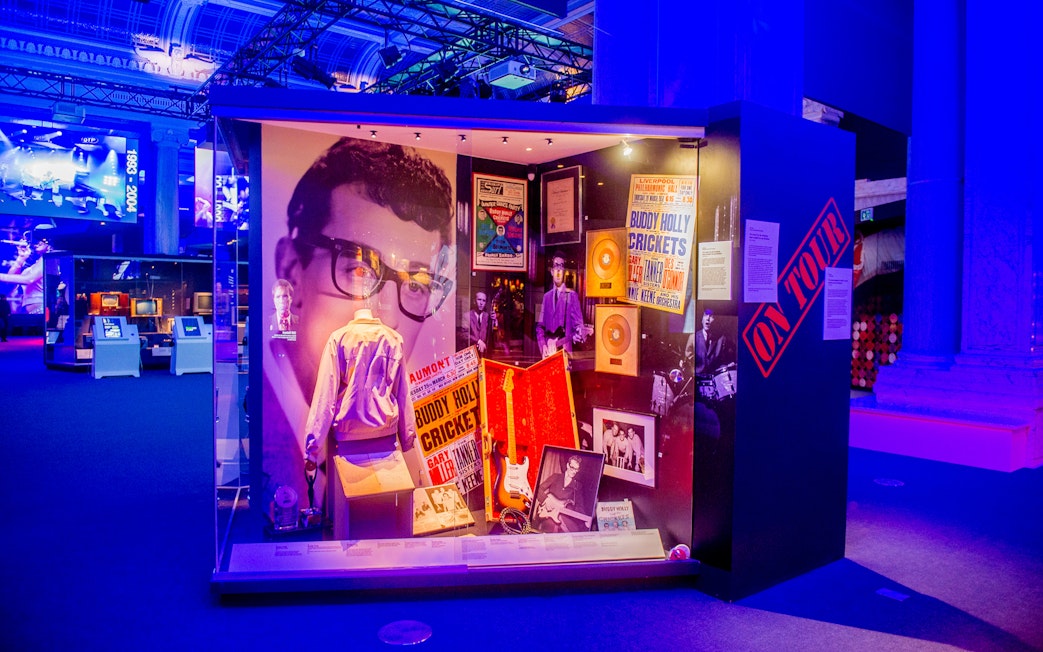 Buddy Holly exhibit at the British Music Experience, featuring memorabilia and posters.