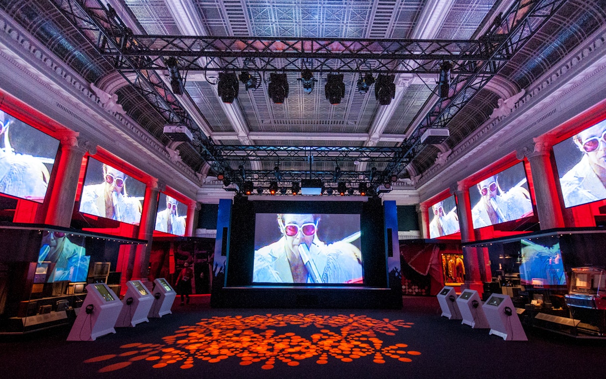 Exhibit hall at The British Music Experience featuring music memorabilia displays.