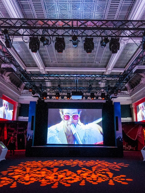 Exhibit hall at The British Music Experience featuring music memorabilia displays.