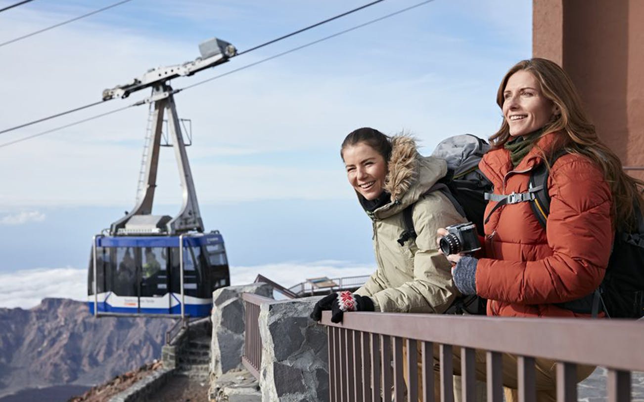Cable car at Mount Teide with tourists enjoying the view near Pico Viejo viewpoint.