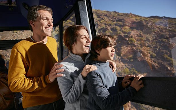 Family enjoying views from Mount Teide cable car on the way to Pico Viejo viewpoint.