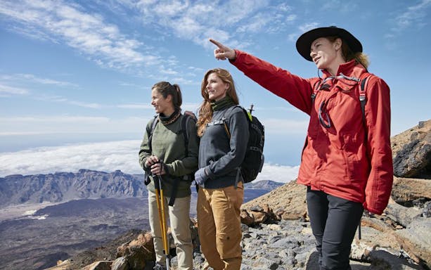 Hikers on Teide Crater with guide pointing, Tenerife.