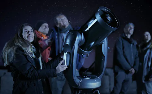 Group stargazing with telescope on Mount Teide during sunset and stars observation tour.