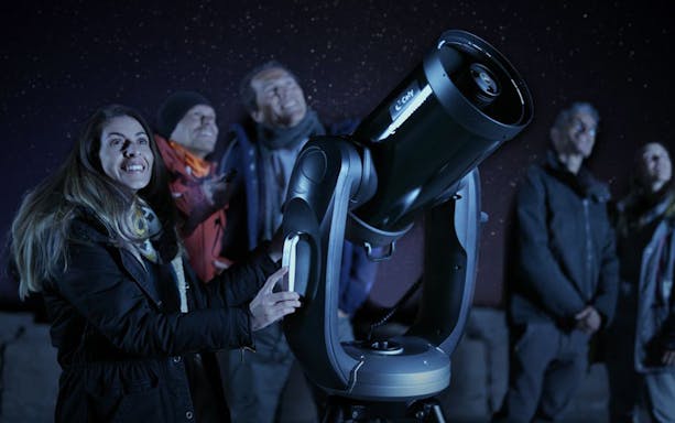 Group stargazing with telescope on Mount Teide during sunset and stars observation tour.