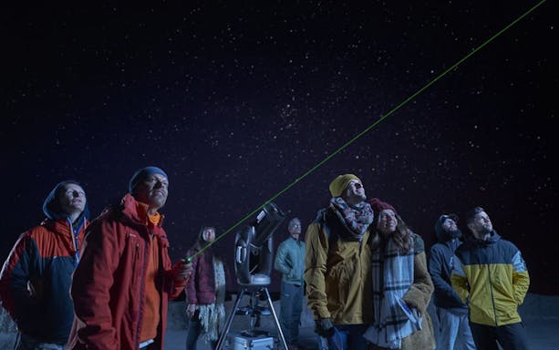 Group stargazing with telescope under clear night sky on Mount Teide tour.