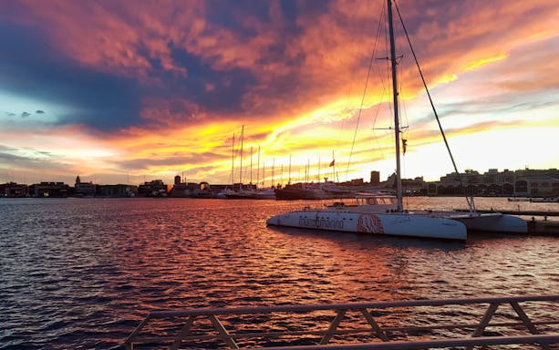 Catamaran docked at sunset in Valencia harbor, part of boat tours and excursions.