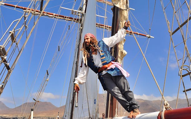 Pirate reenactor on ship deck, Fuerteventura La Aventura Pirata tour.