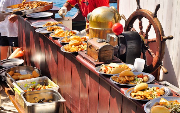 Pirate ship buffet with assorted dishes on Fuerteventura La Aventura Pirata tour.