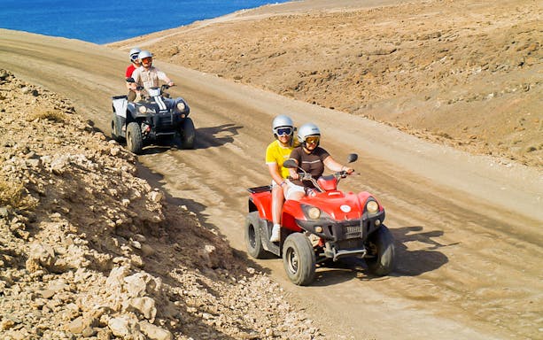 ATV riders exploring desert terrain in Fuerteventura Land Experience.