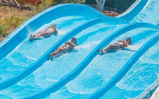 Visitors enjoying water slides at Terra Natura Murcia.