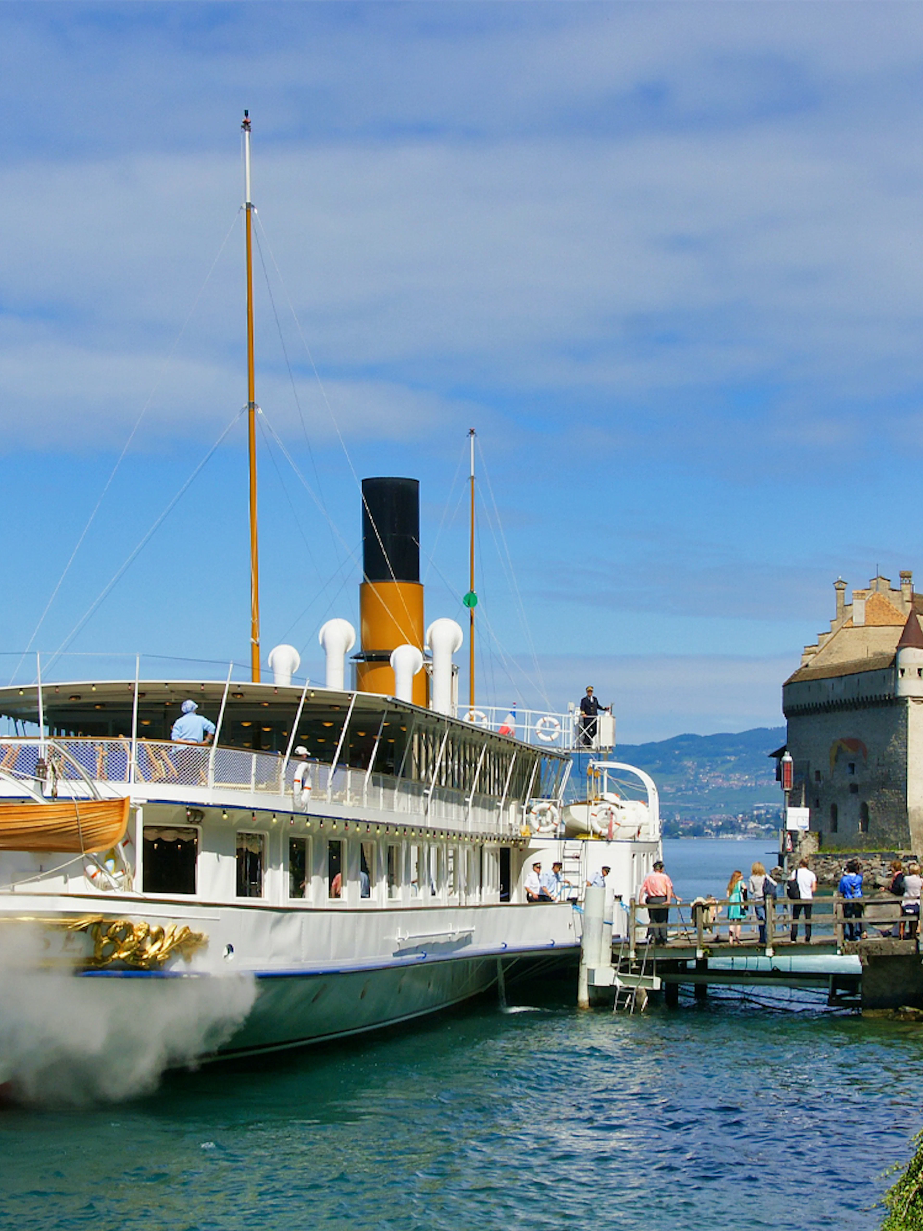 Cruise ship docked near Chillon Castle on Lake Geneva, Montreux.