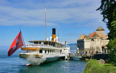 Cruise ship docked near Chillon Castle on Lake Geneva, Montreux.