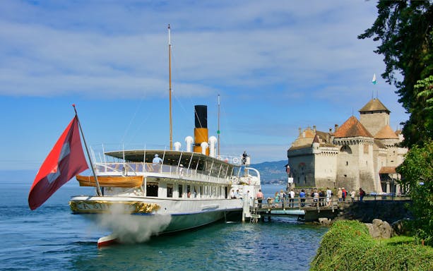 Cruise ship docked near Chillon Castle on Lake Geneva, Vevey.
