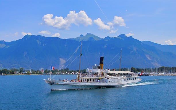 Cruise ship on Lake Geneva with mountains in the background, near Vevey.