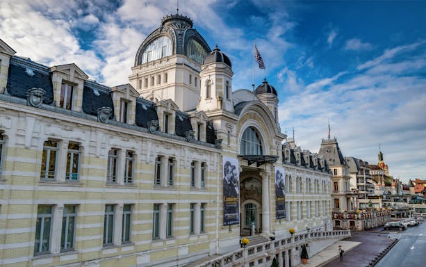 Lausanne to Evian ferry terminal with historic architecture and banners.