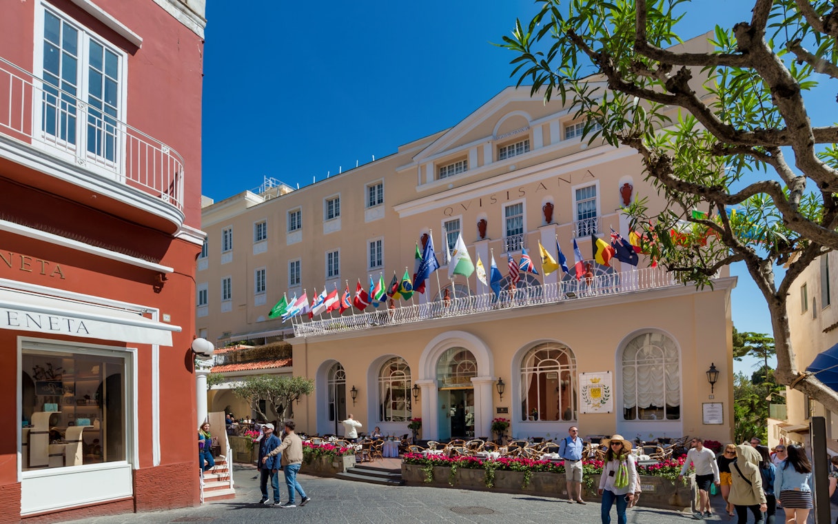 Elegant building with international flags in Capri, Italy, part of the Capri Full Day Private Tour from Naples Port.