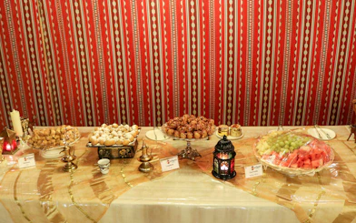 Traditional Middle Eastern dessert spread with lantern, part of Desert Wonder evening safari experience.
