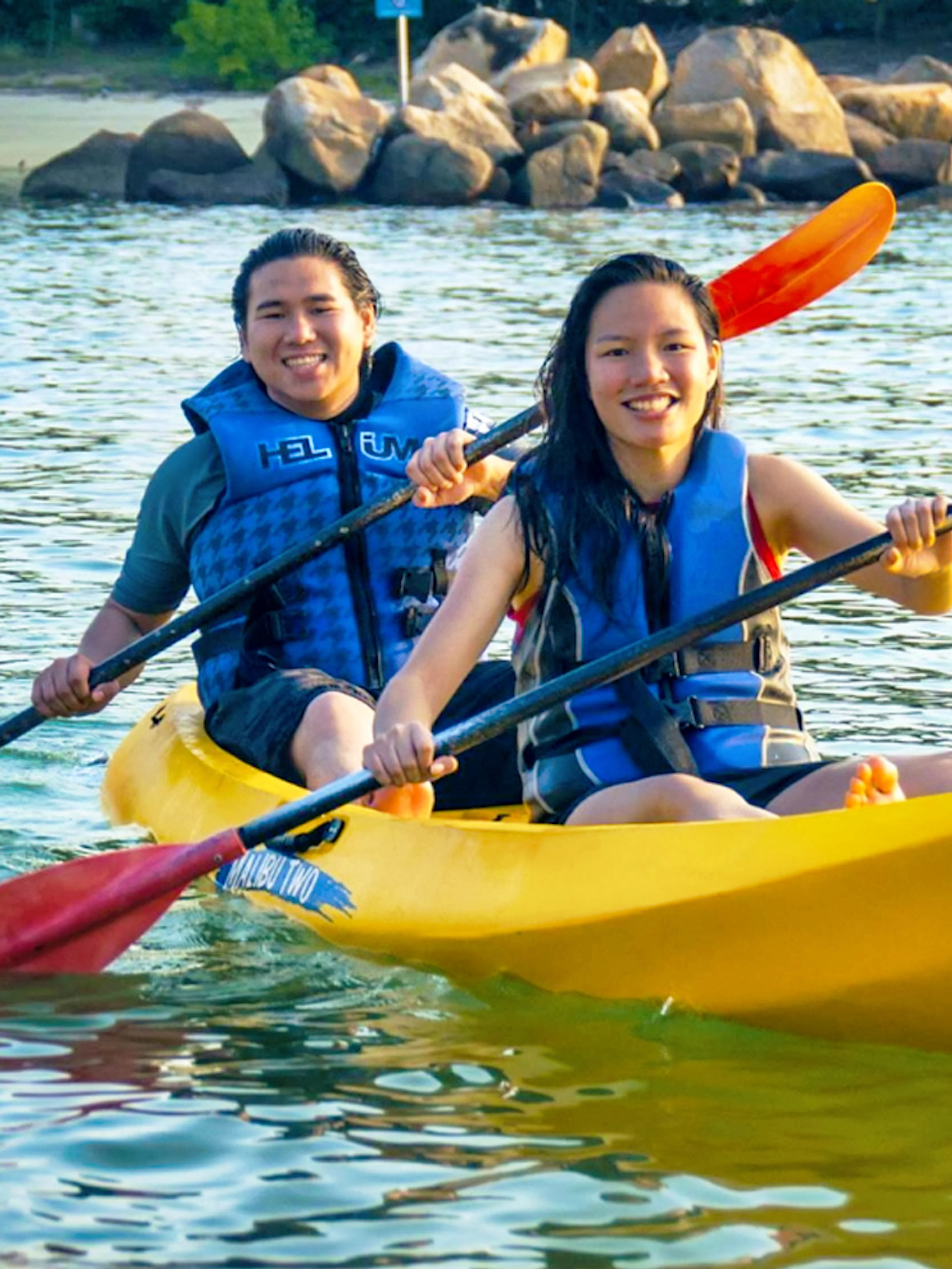 Two people kayaking at Ola Beach Club, Singapore.